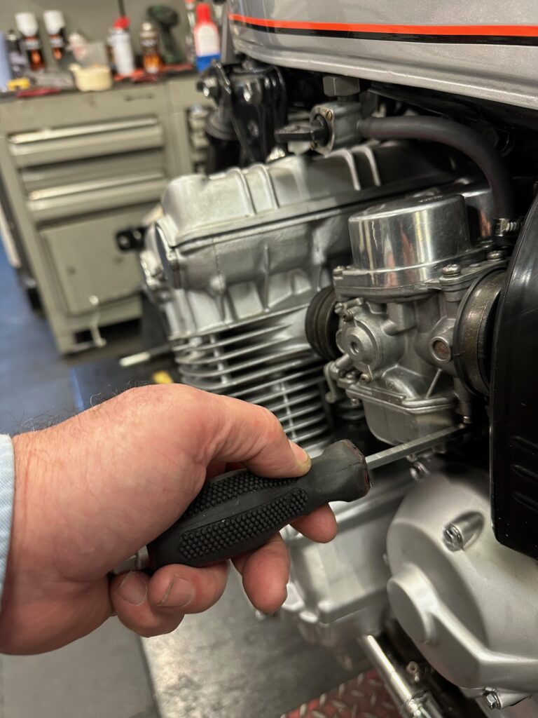 Certified technician servicing a Vespa scooter